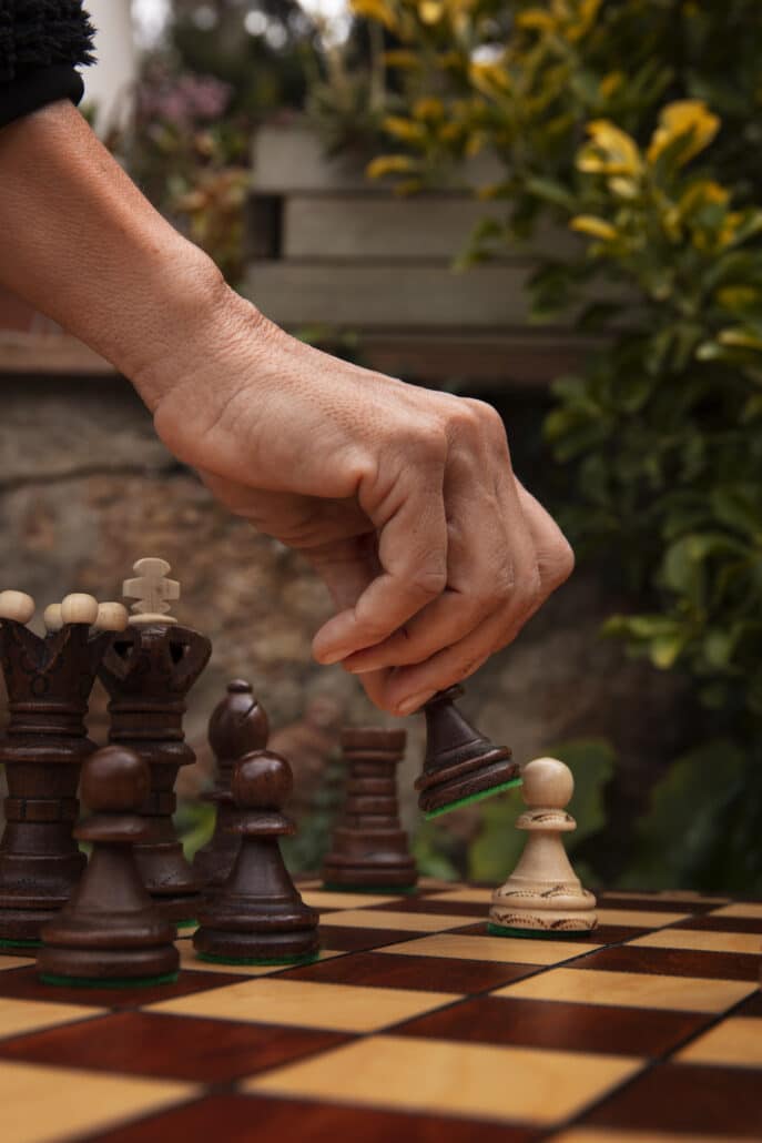 hand playing chess classic board